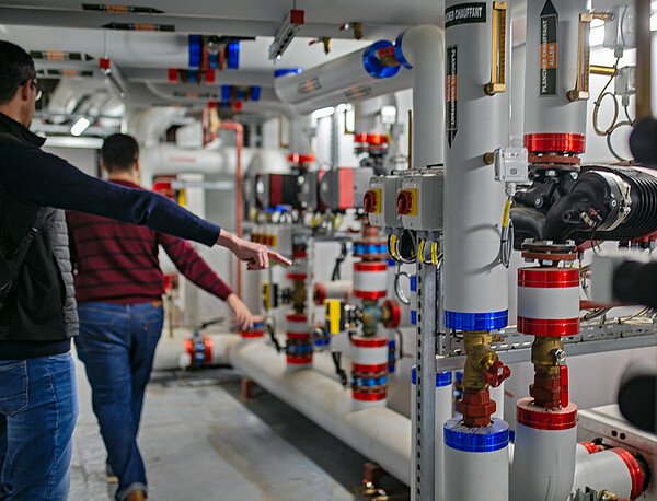 Visite de contrôle dans une sous-station de chauffage, où se situent également les centrales de traitement d'air, qui permettent de gérer la ventilation, le chauffage et l'hygrométrie du Studium. © Catherine Schröder / Unistra